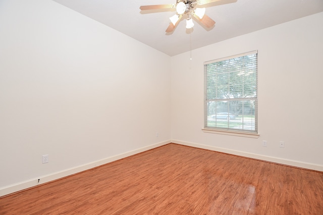 empty room featuring hardwood / wood-style floors and ceiling fan