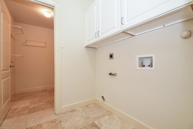 washroom featuring gas dryer hookup, washer hookup, cabinets, and hookup for an electric dryer