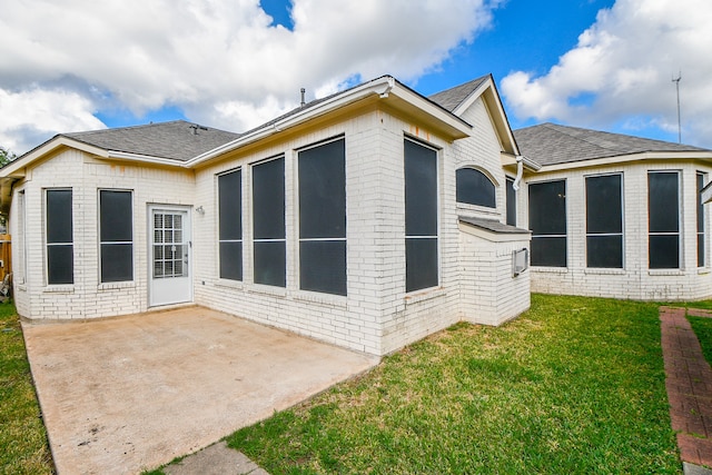 back of house featuring a patio area and a yard