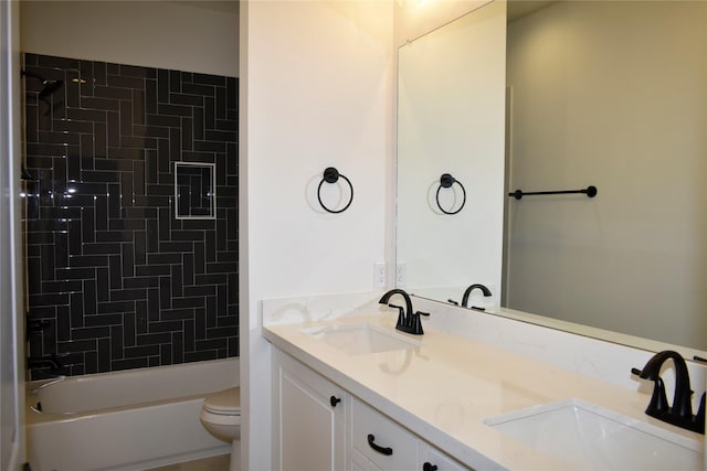 full bathroom with tiled shower / bath, vanity, and toilet