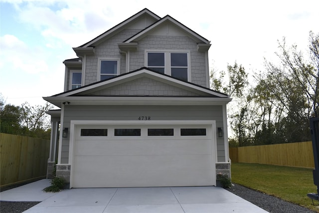 craftsman-style house with a front lawn and a garage