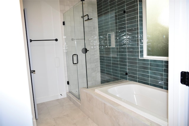 bathroom featuring tile patterned floors and shower with separate bathtub