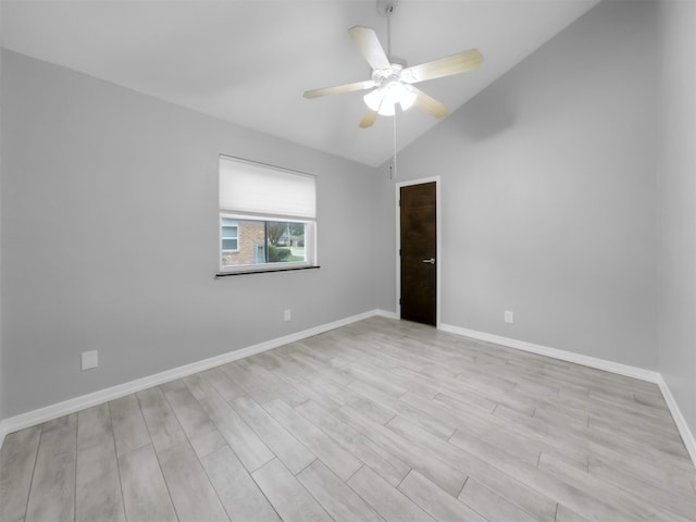 empty room with light hardwood / wood-style flooring, ceiling fan, and vaulted ceiling