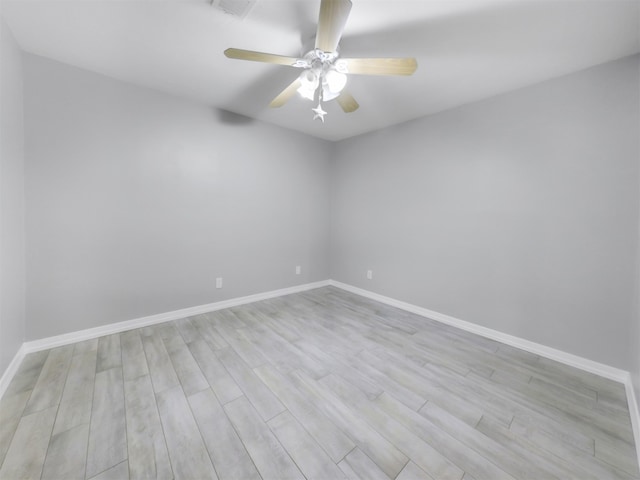 empty room featuring light wood-type flooring and ceiling fan