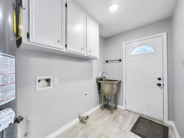 laundry area with hookup for a washing machine, cabinets, hookup for an electric dryer, and light wood-type flooring