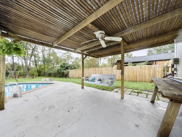 view of patio / terrace with ceiling fan and a fenced in pool