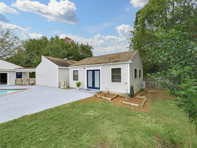 rear view of house featuring a yard, a patio, french doors, and central air condition unit