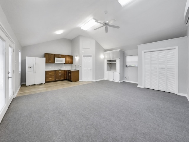 unfurnished living room featuring lofted ceiling, light carpet, and ceiling fan