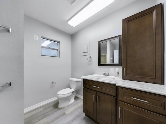 bathroom featuring vanity, hardwood / wood-style flooring, and toilet