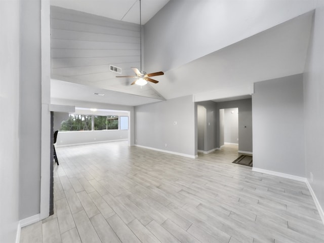 unfurnished living room featuring ceiling fan, high vaulted ceiling, and light wood-type flooring