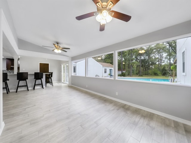 interior space featuring lofted ceiling, light wood-type flooring, and ceiling fan