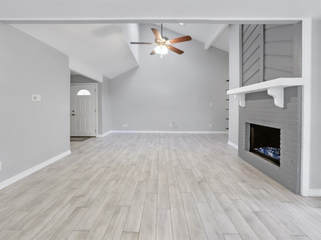 unfurnished living room with light hardwood / wood-style floors, lofted ceiling, a brick fireplace, and ceiling fan