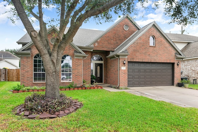 view of front of home with a front lawn and a garage