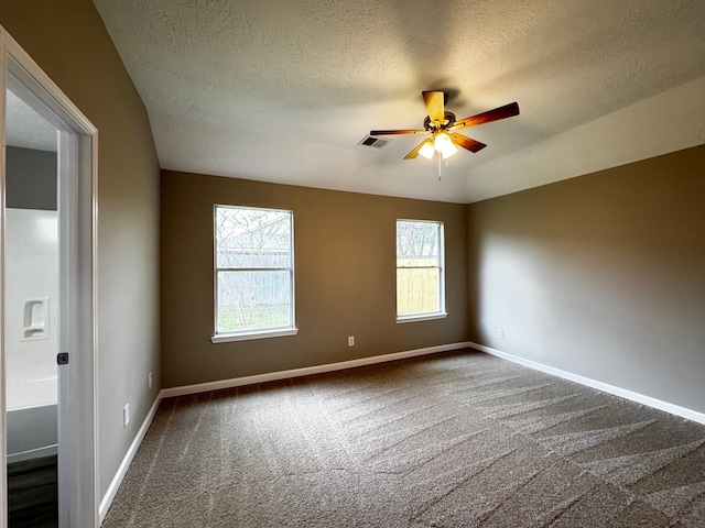 carpeted empty room featuring ceiling fan, a textured ceiling, and lofted ceiling