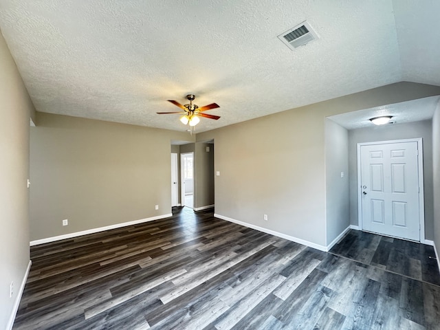 spare room with dark wood-type flooring, ceiling fan, and a textured ceiling