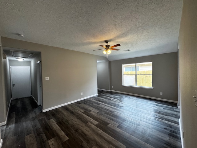 spare room with dark wood-type flooring, a textured ceiling, and ceiling fan