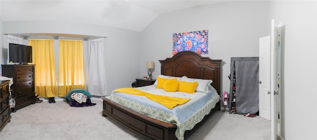 carpeted bedroom featuring lofted ceiling