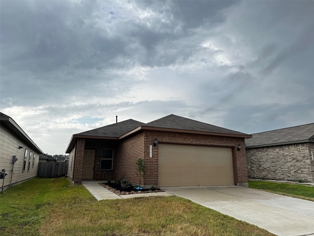 view of front of property with a front yard and a garage