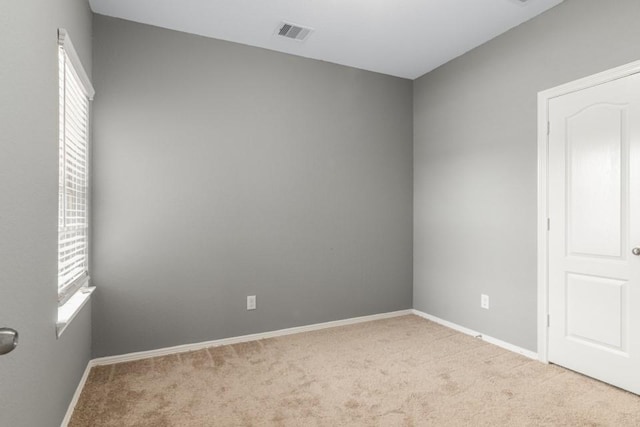 unfurnished room with light carpet