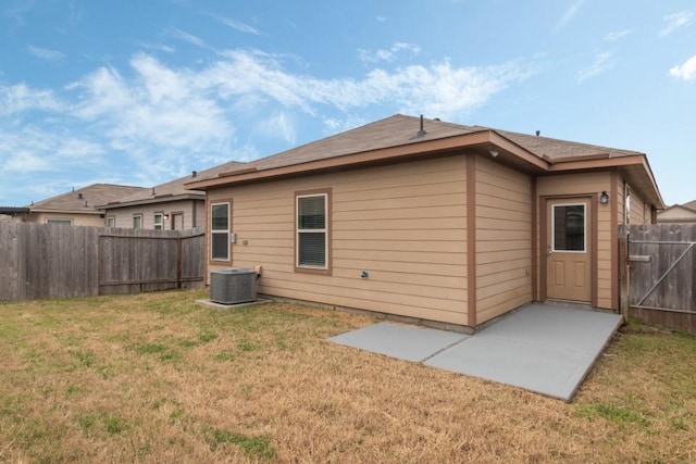 back of house featuring a yard, cooling unit, and a patio area