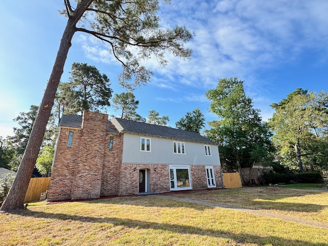 rear view of property with a yard