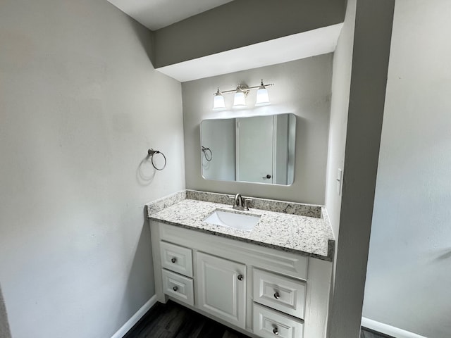 bathroom with vanity and wood-type flooring