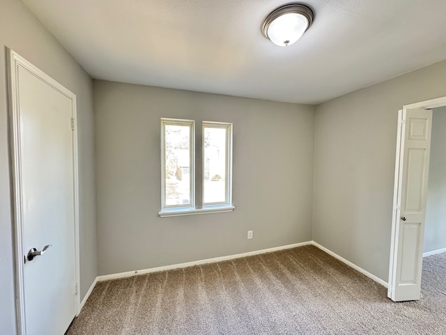 unfurnished room with carpet floors