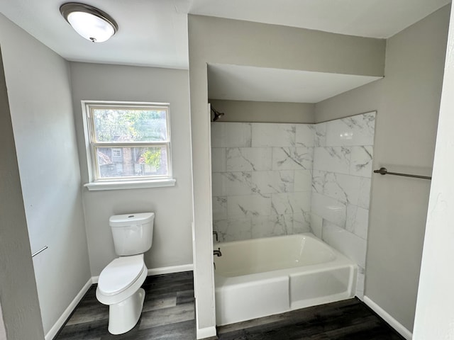 bathroom featuring toilet, tiled shower / bath combo, and hardwood / wood-style flooring