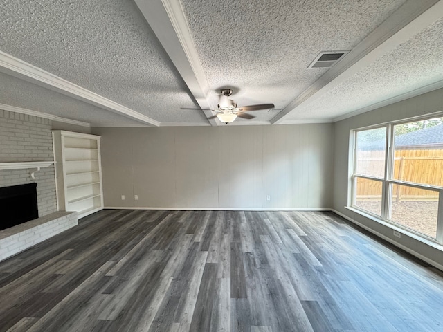 unfurnished living room featuring dark wood-type flooring, a brick fireplace, and a textured ceiling