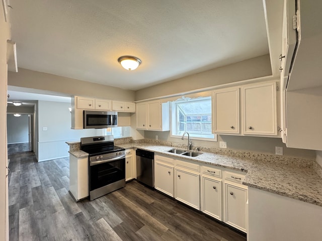 kitchen featuring white cabinetry, stainless steel appliances, sink, and dark hardwood / wood-style floors