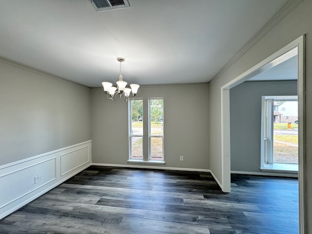 spare room featuring crown molding, dark wood-type flooring, and a healthy amount of sunlight