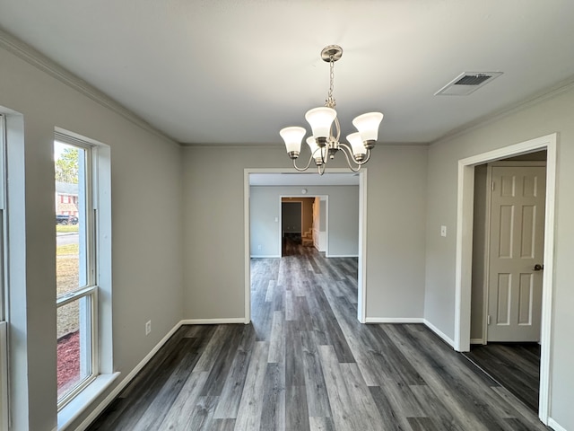 unfurnished dining area with ornamental molding, dark wood-type flooring, and a chandelier