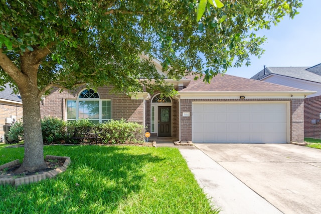 ranch-style home with a front yard and a garage