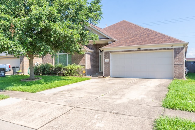 view of front facade featuring a front lawn and a garage