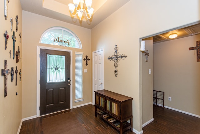 entrance foyer with dark hardwood / wood-style flooring and a chandelier