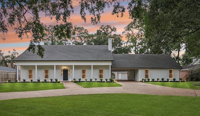 view of front of house with a yard and a porch