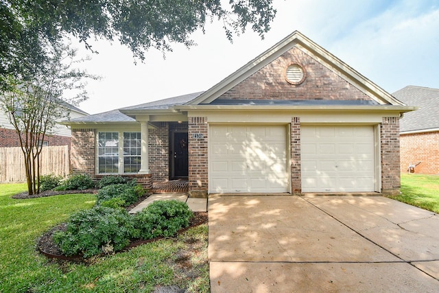 ranch-style house featuring a front yard and a garage