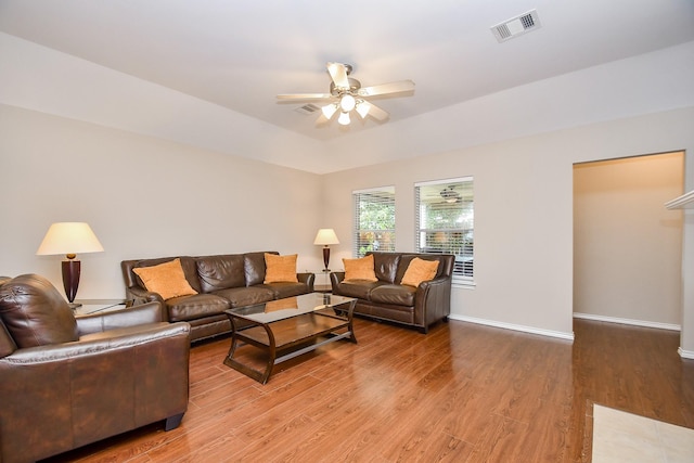 living room featuring hardwood / wood-style flooring, vaulted ceiling, and ceiling fan