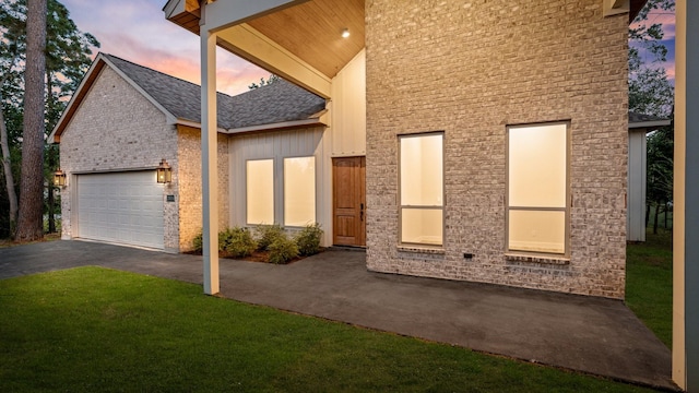 exterior space featuring a lawn and a garage