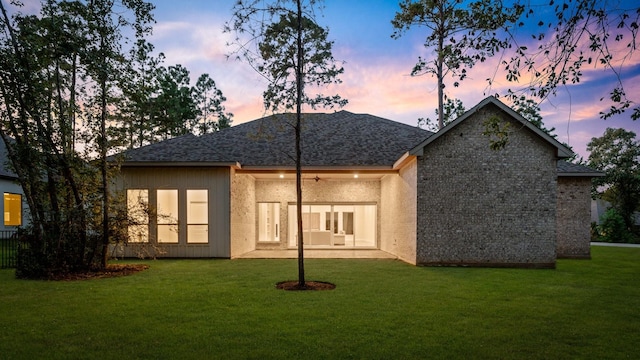 back house at dusk with a yard