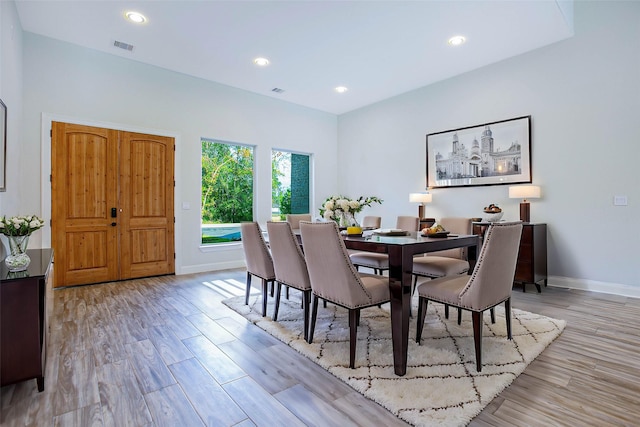 dining space with light hardwood / wood-style floors