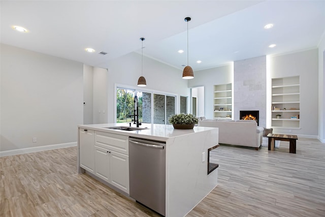 kitchen featuring white cabinets, a kitchen island with sink, pendant lighting, dishwasher, and lofted ceiling