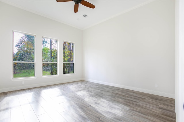 empty room with ceiling fan, hardwood / wood-style floors, and crown molding