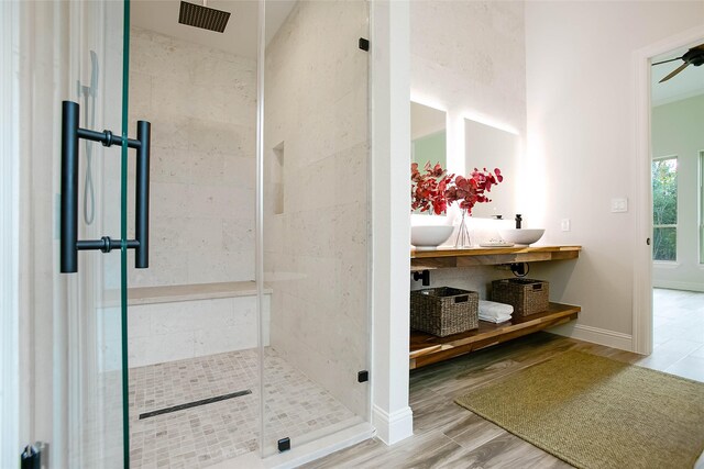 bathroom featuring hardwood / wood-style flooring, vanity, ceiling fan, and a shower with door