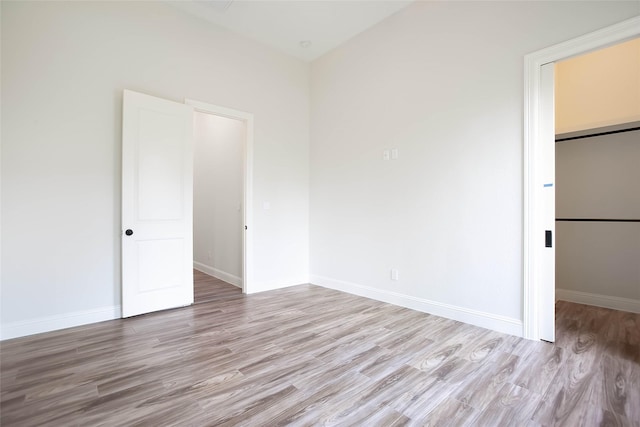 unfurnished bedroom featuring a closet and light hardwood / wood-style floors