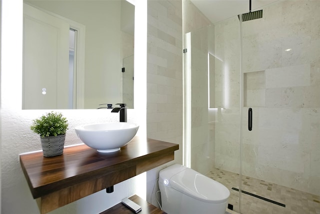 bathroom featuring sink, an enclosed shower, and toilet