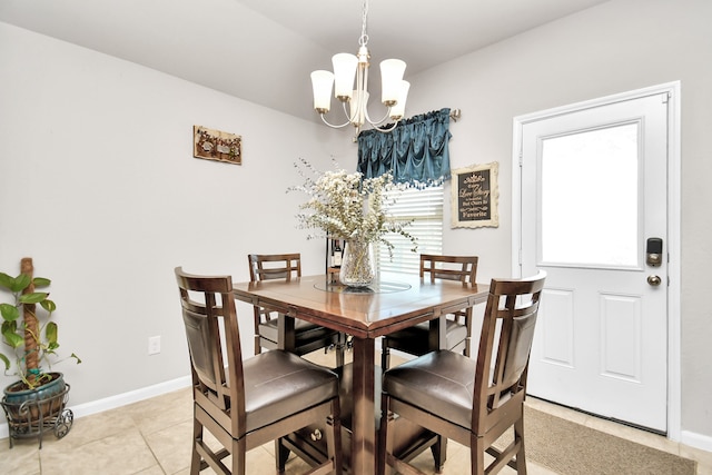 tiled dining space with a healthy amount of sunlight and an inviting chandelier