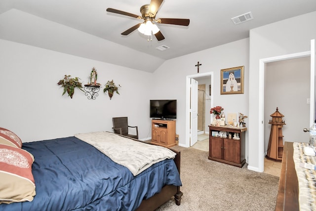 bedroom featuring light colored carpet, connected bathroom, vaulted ceiling, and ceiling fan