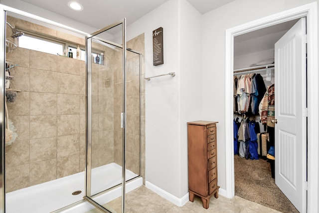 bathroom featuring a shower with door and tile patterned flooring