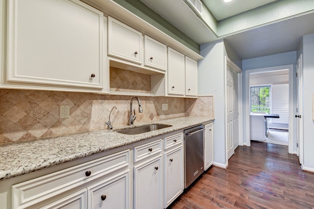 kitchen featuring stainless steel dishwasher, sink, light stone countertops, and dark hardwood / wood-style flooring